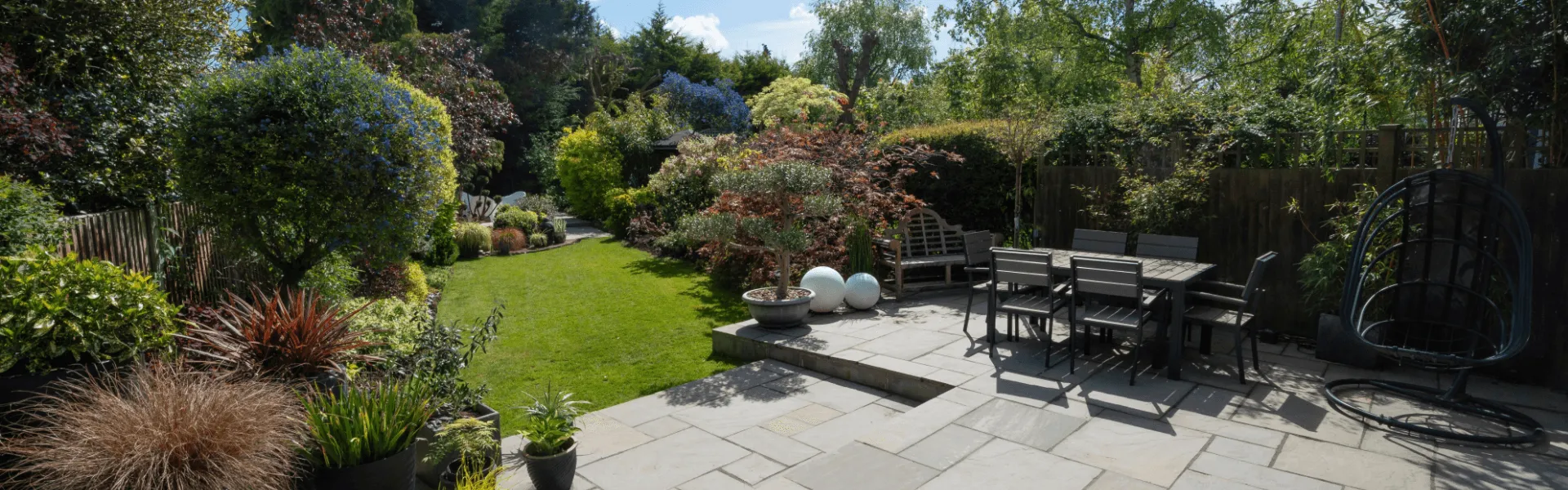 Tranquil outdoor patio and garden area Beautiful garden with patio seating and lush greenery