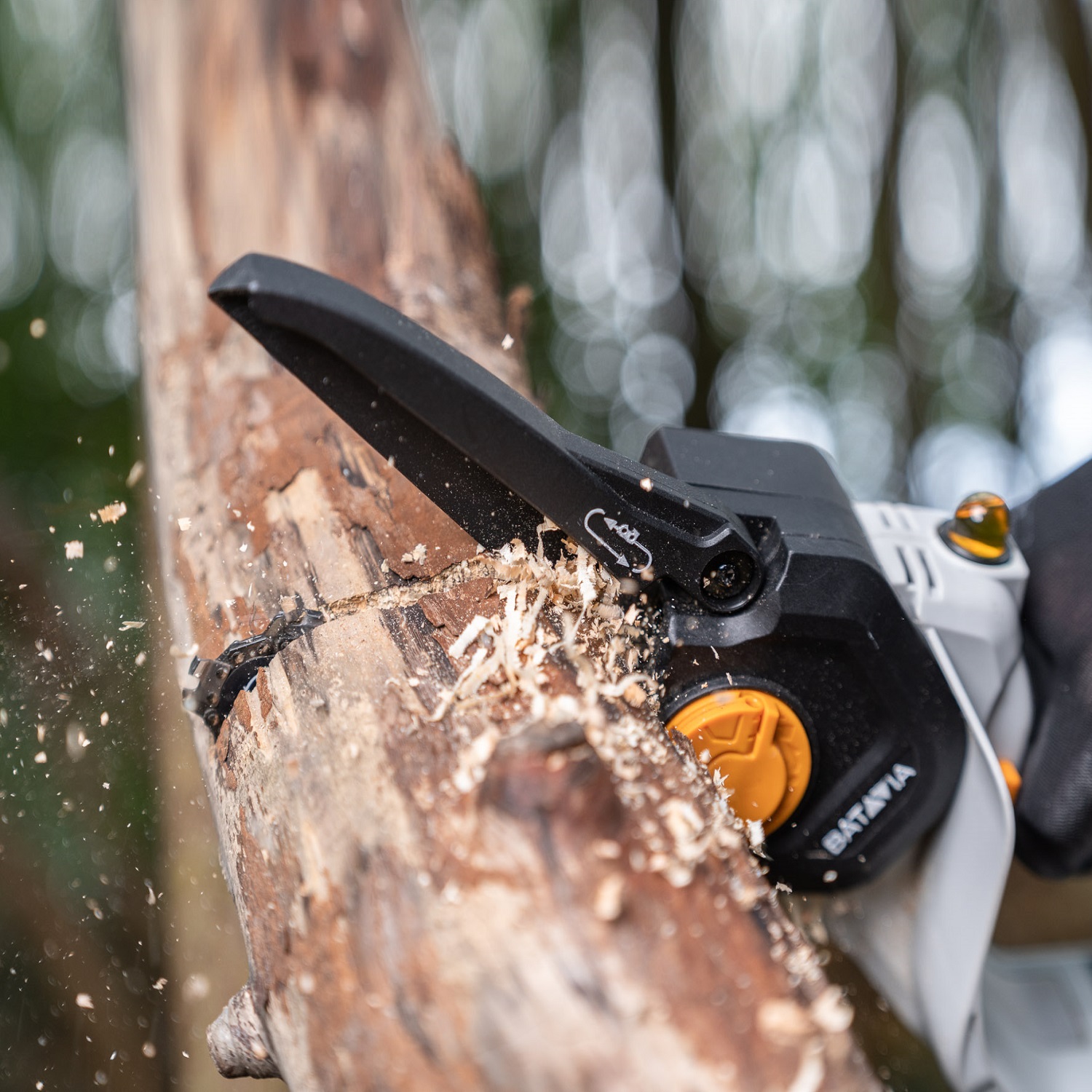 Close-up of Batavia NEXXSAW 18V Cordless One-Handed Pruning Chainsaw cutting through a wooden branch.