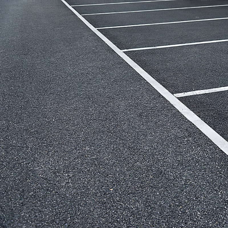 Parking lot with freshly painted white traffic lines on asphalt.