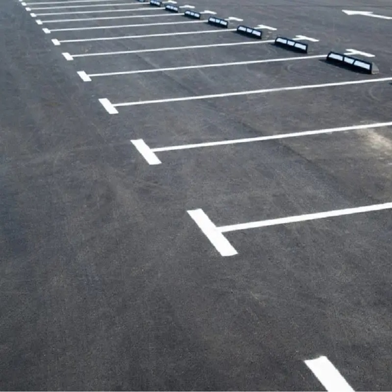 Freshly painted white traffic lines in a parking area.