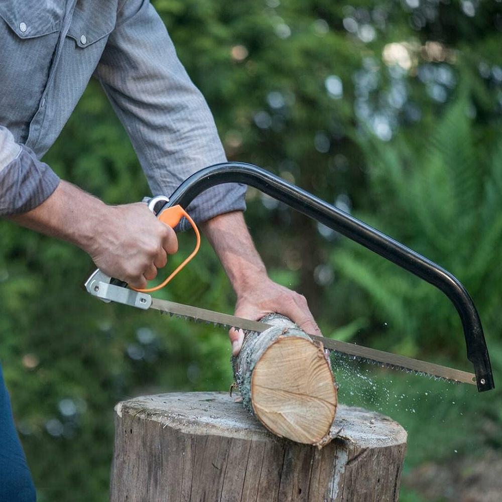 Fiskars 21-Inch Tree Pruning Bowsaw cutting log on splitting log