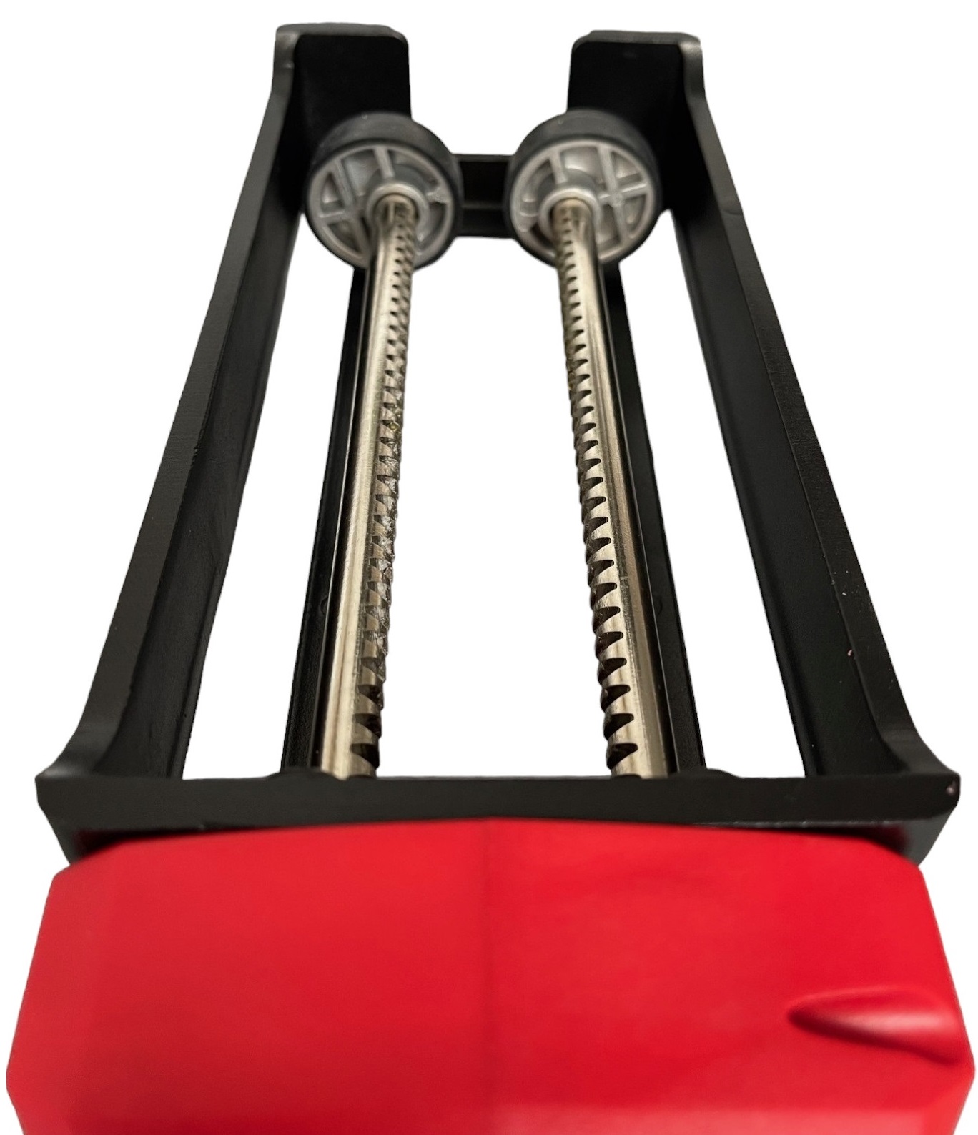 Close-up view of the Joint It electric battery epoxy grout application gun showing the dual metal rods and red casing.
