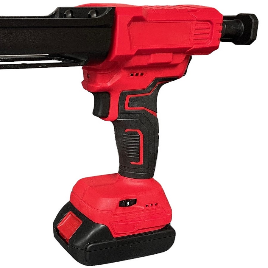 Red electric battery-powered epoxy grout application gun with a black handle.