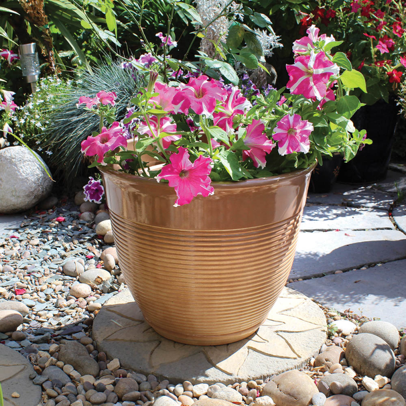A 15-inch mottled ceramic flower pot with pink flowers in a garden setting.