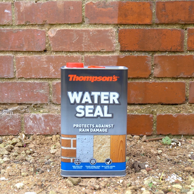Thompsons One Coat Water Seal 5L container placed in front of a brick wall, used for waterproofing masonry, stone, and wood.