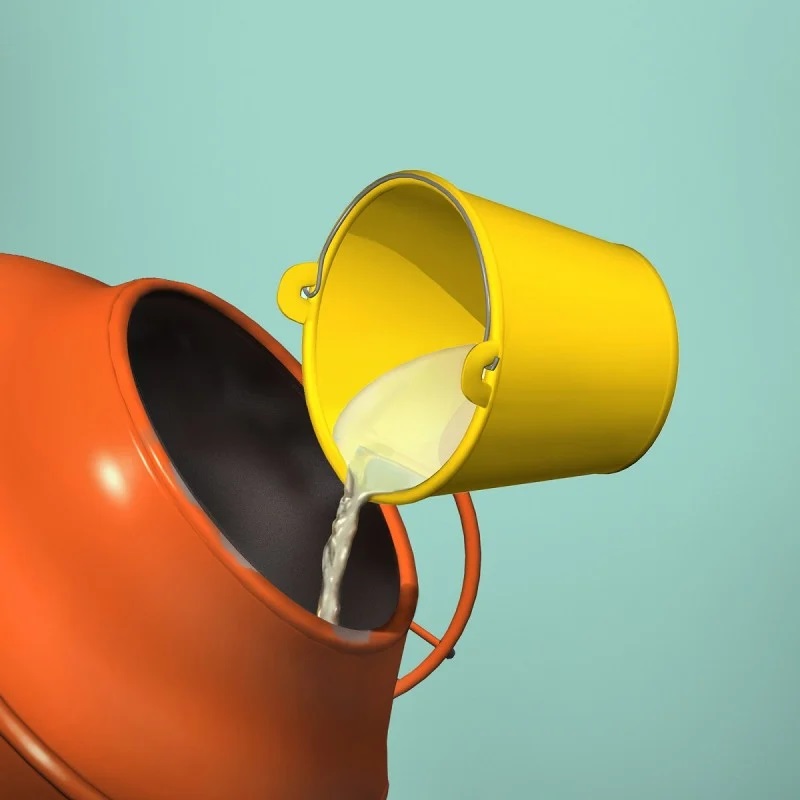 Yellow bucket pouring liquid into an orange cement mixer.