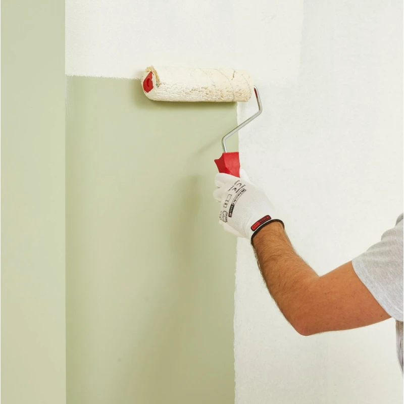 Person wearing BlackRock Lightweight Gripper Work Gloves using a paint roller on a wall