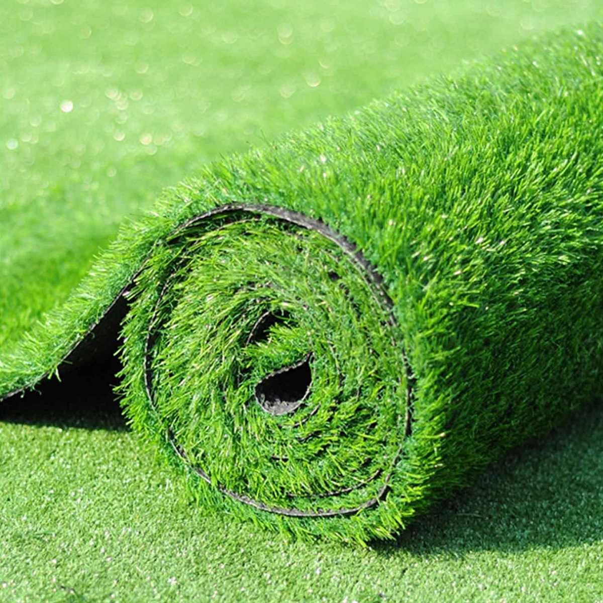 Roll of green artificial grass on a lawn