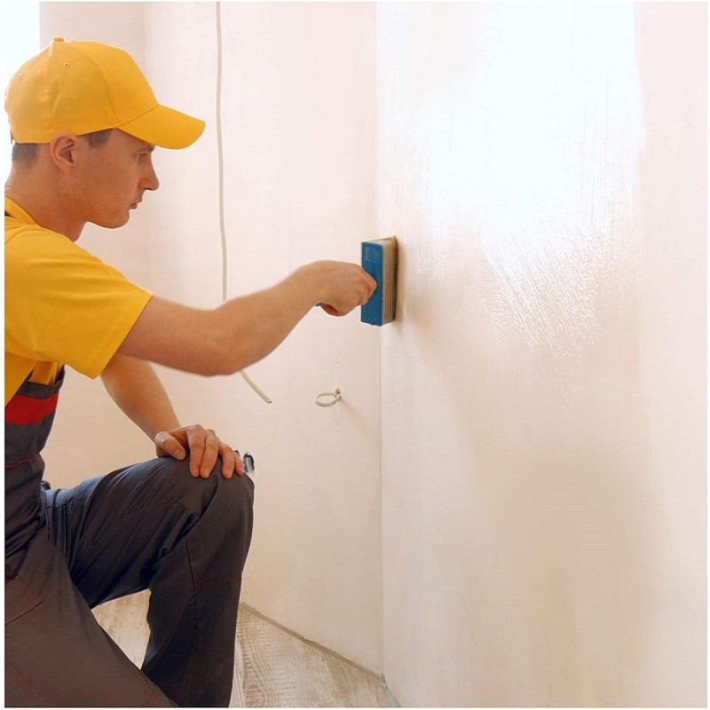 Person applying PVA to a wall surface with a sponge.