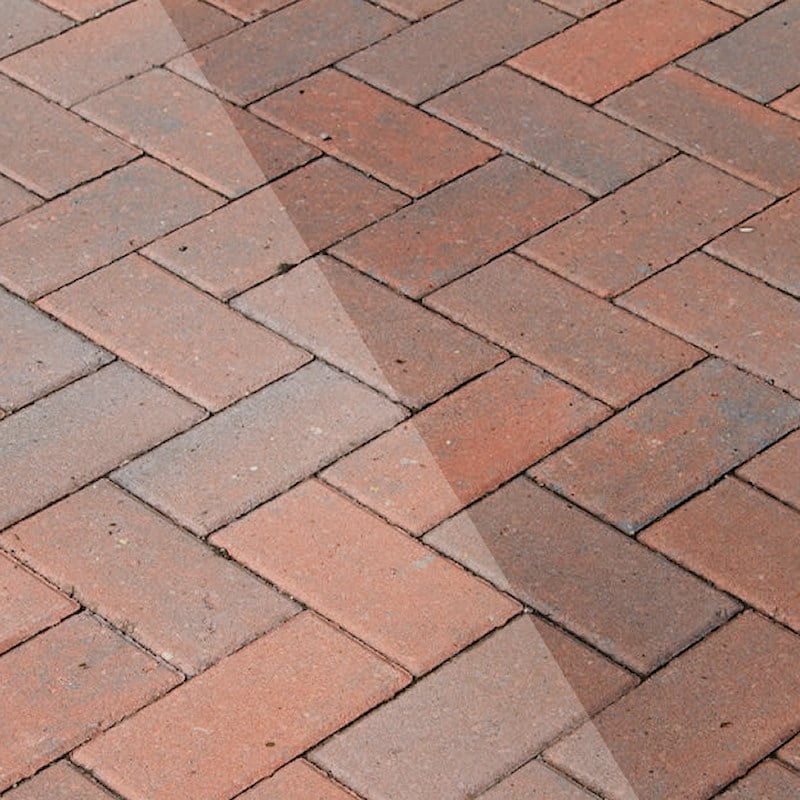Comparison of block paving with and without clear coat sealer, showing enhanced colour and protection.