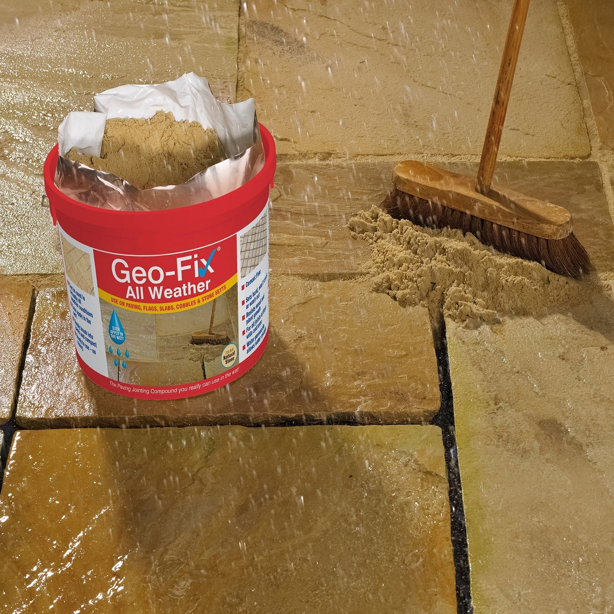 Geo-Fix All Weather Jointing Compound in use on stone paving with a broom nearby.
