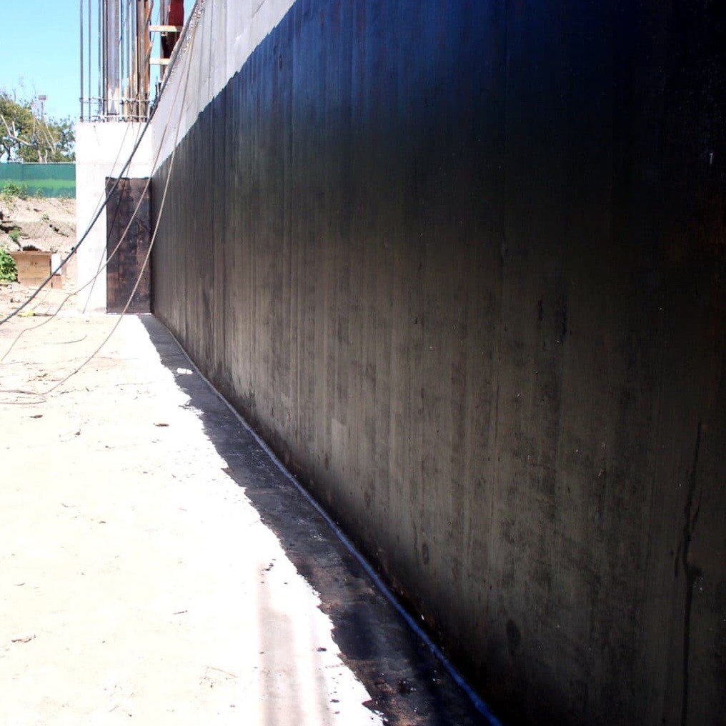 Exterior wall coated with black damp proof liquid membrane