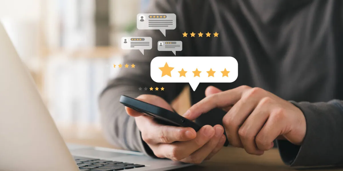 Person using a smartphone with digital reviews and star ratings overlay