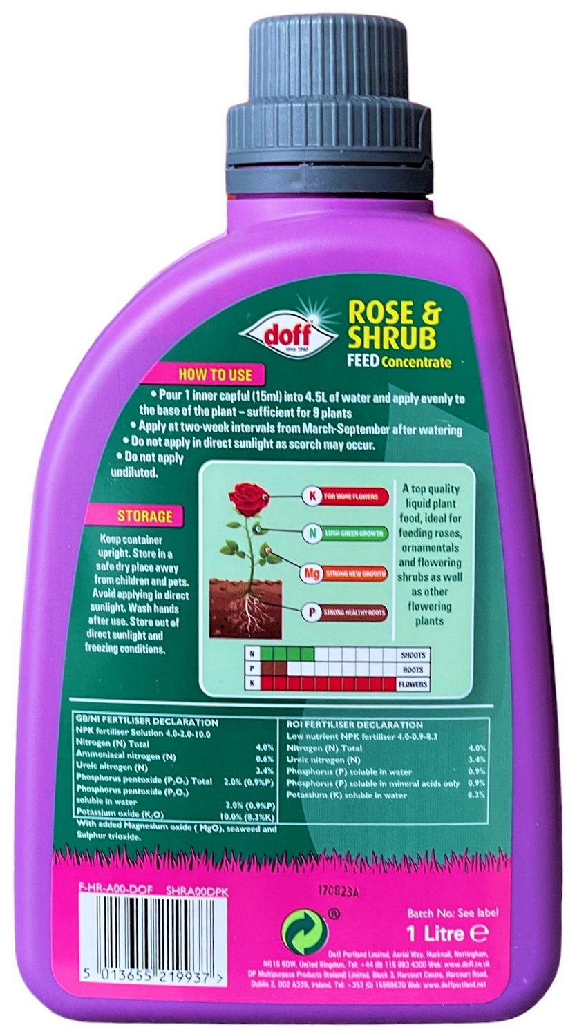 Back view of a purple bottle of Doff Liquid Rose Plant and Shrub Feed Concentrate, showing instructions and nutrient information.