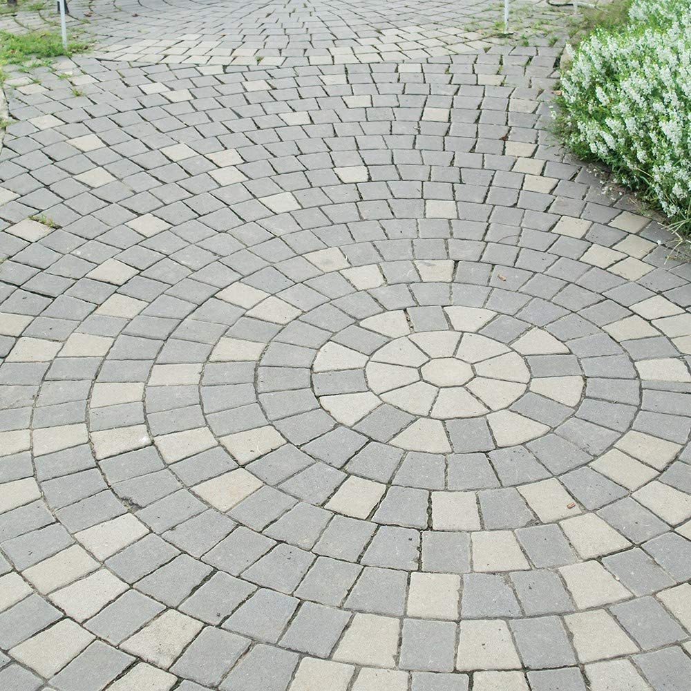 Circular pattern of clean paving stones with surrounding greenery.