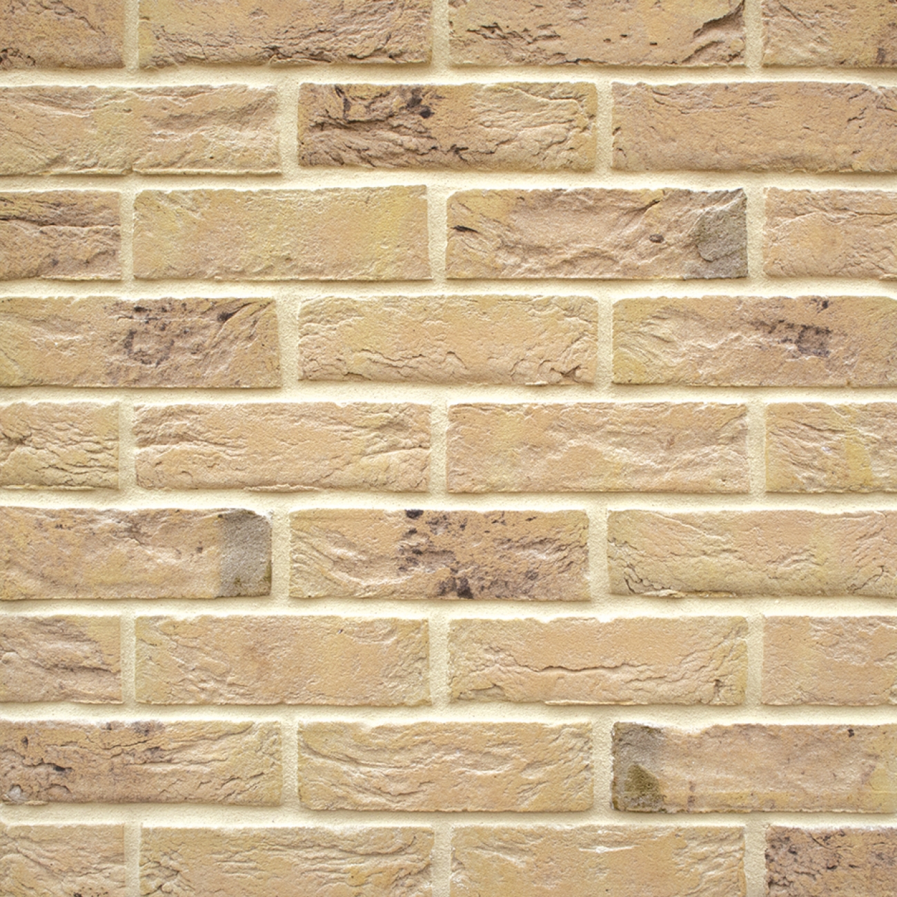 Textured beige brick surface with subtle light buff mortar joints for a soft, neutral finish