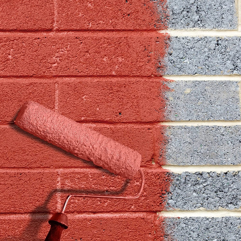 A roller applying red bonding coating to a brick wall, showing the contrast between treated and untreated surfaces.