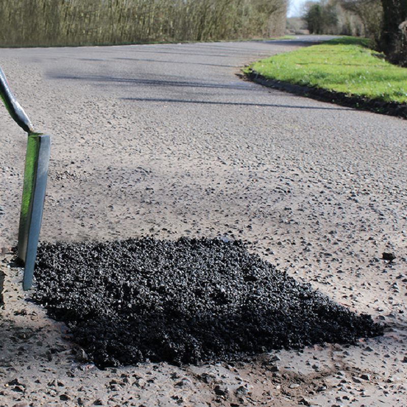A patch of freshly applied tarmac on a road using Bond It Instant Pot Hole Repair.