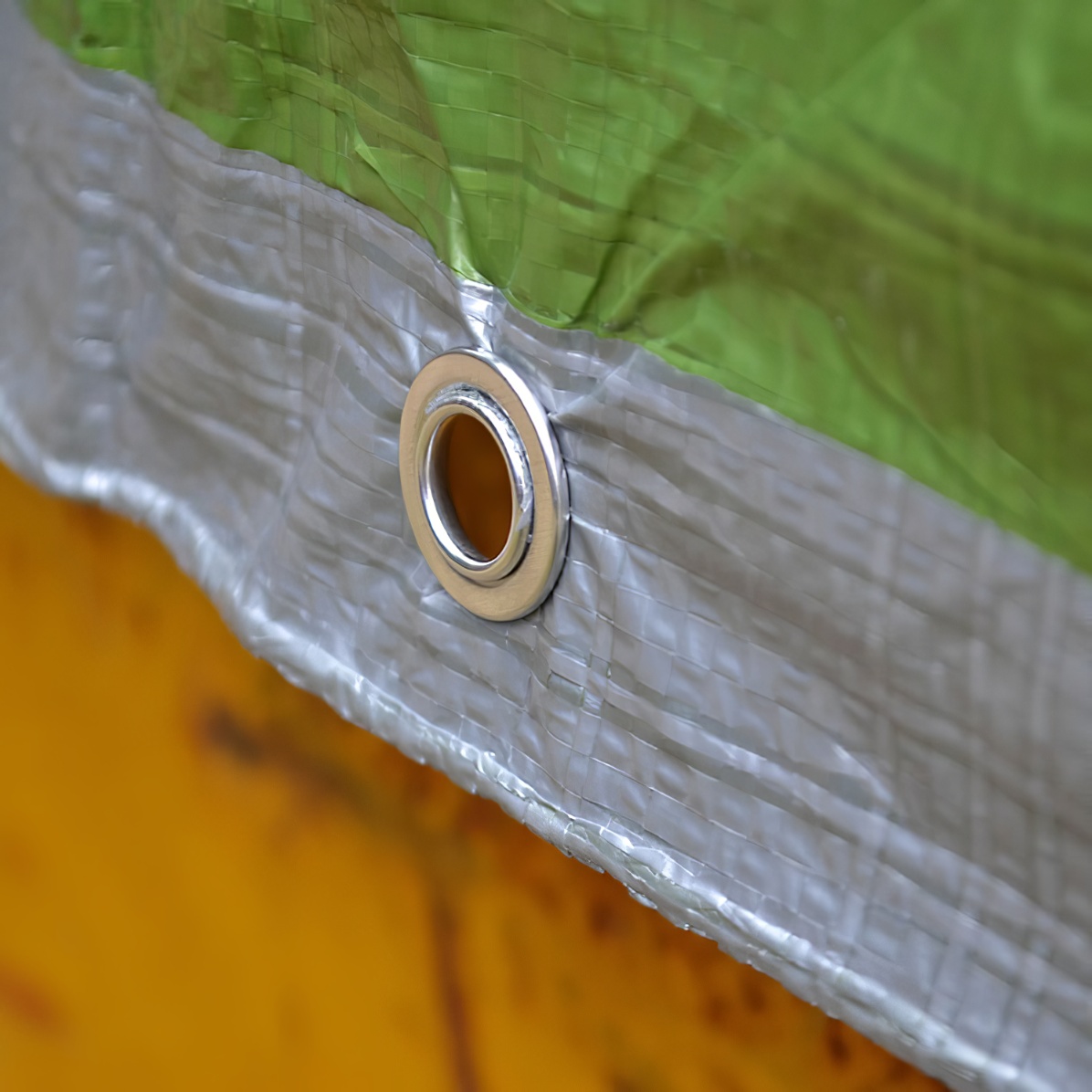 Green and silver reversible tarpaulin with eyelets, measuring 12ft by 9ft, tie down eyelets