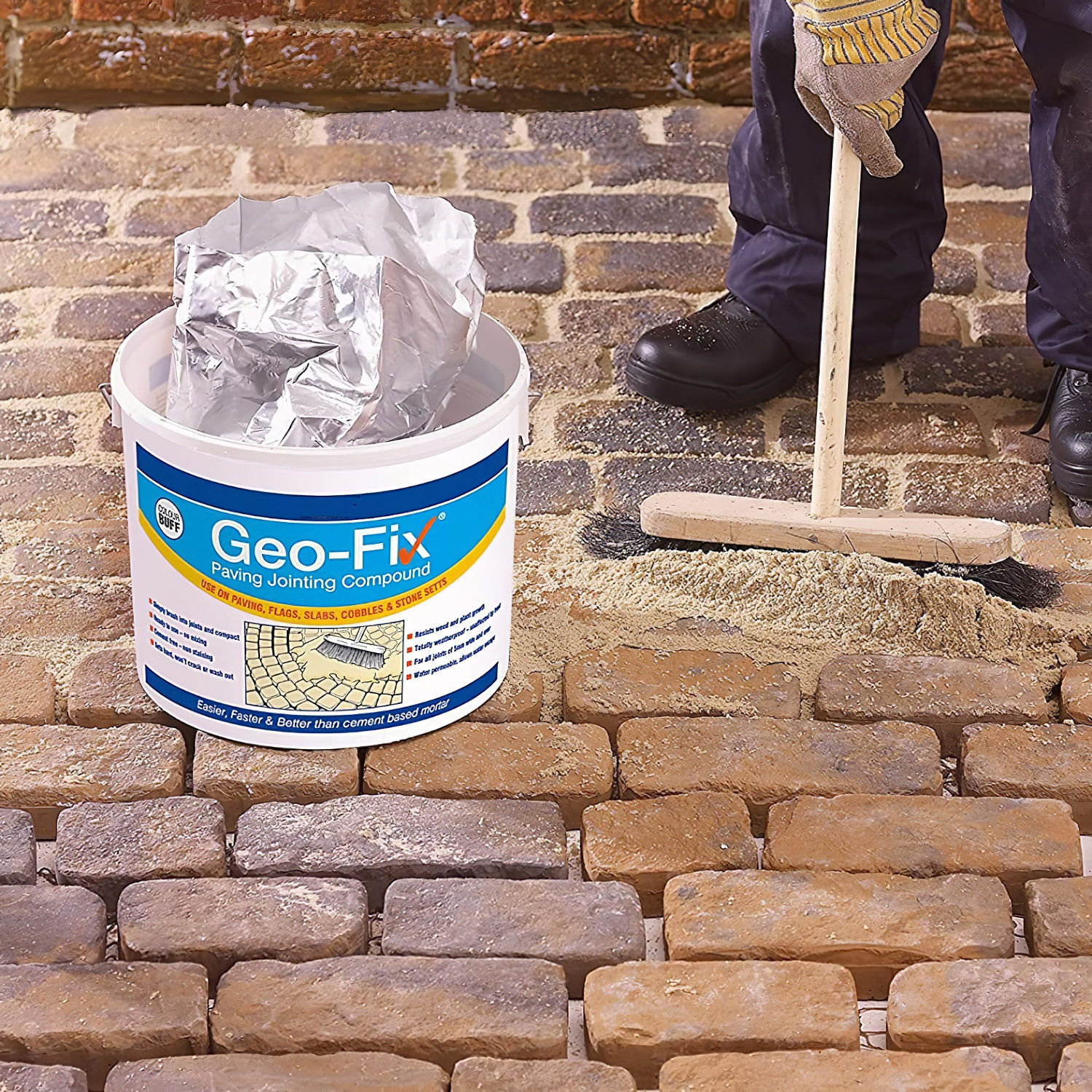 Applying Geo-Fix compound to cobblestone surface with brush for joint filling