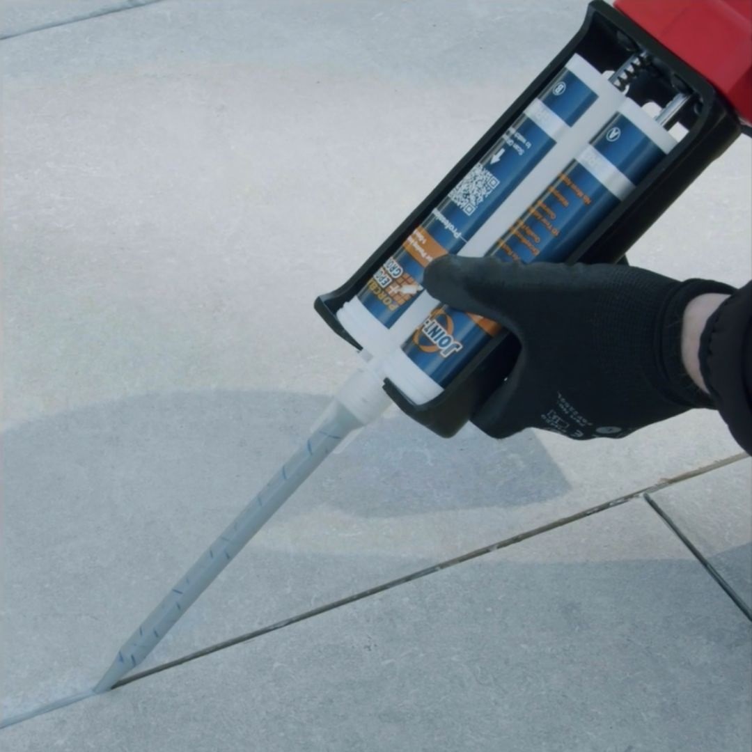 Person using Joint It Porcelain Epoxy Grout Mixing Nozzle on tiles
