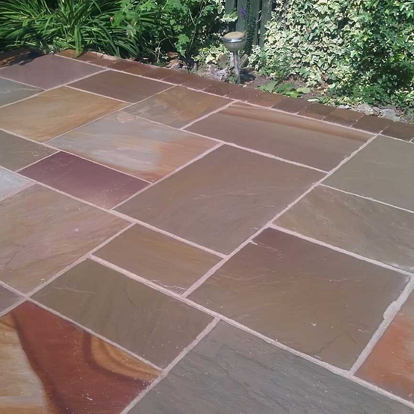 Natural stone patio with enhanced colours and sealed surface.