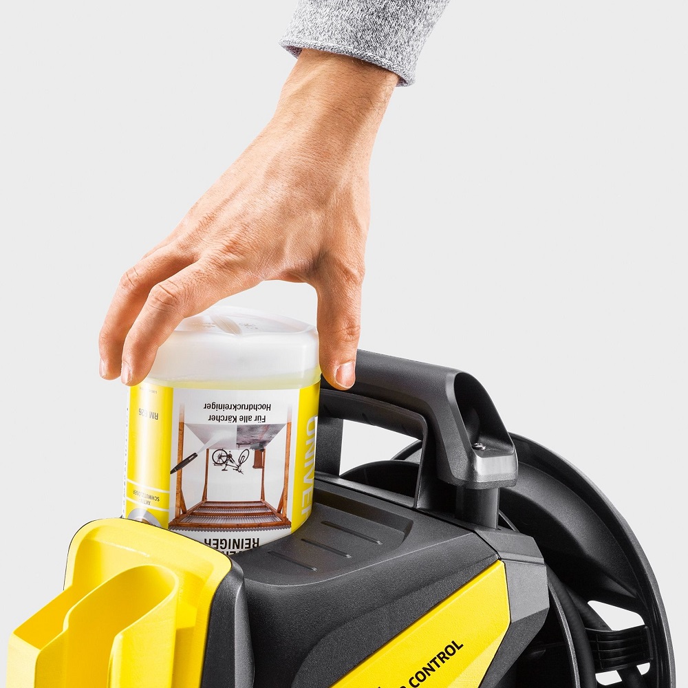 Hand placing Karcher Universal Pressure Washer Cleaner Concentrate 1L on a pressure washer