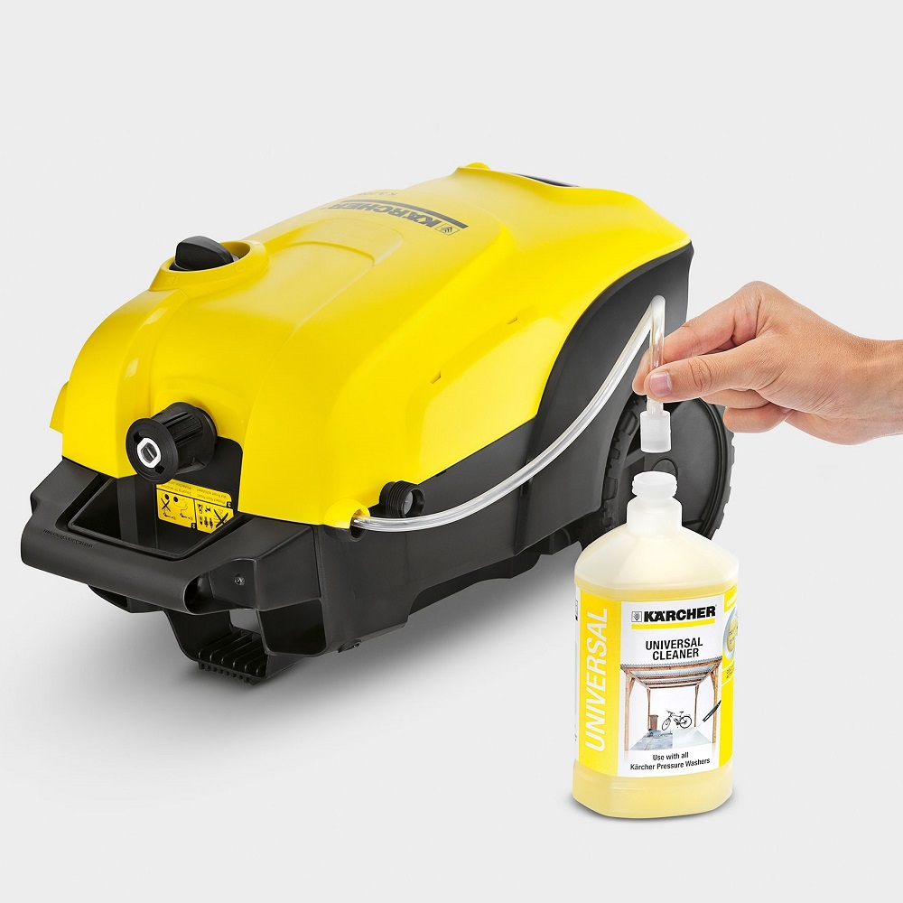 Hand attaching Karcher Universal Pressure Washer Cleaner Concentrate to a yellow and black pressure washer.