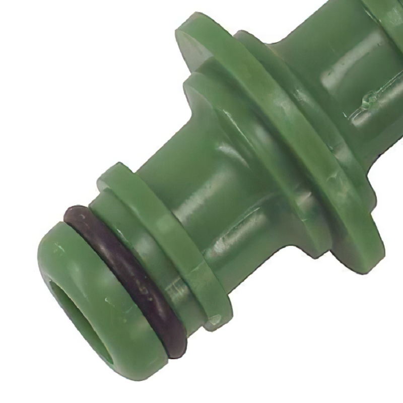 Close-up of a green garden hose male adapter with an O-ring.