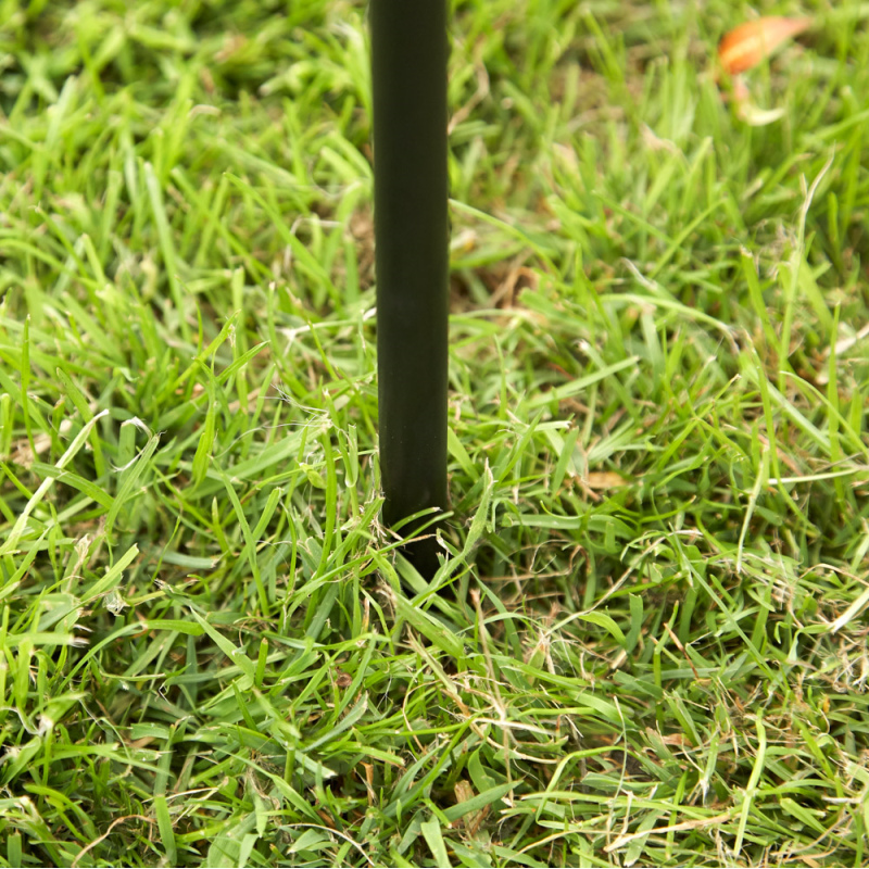 Close-up of a metal post inserted into grass, part of the Kingfisher Garden Tubular Metal Archway for climbing plants.