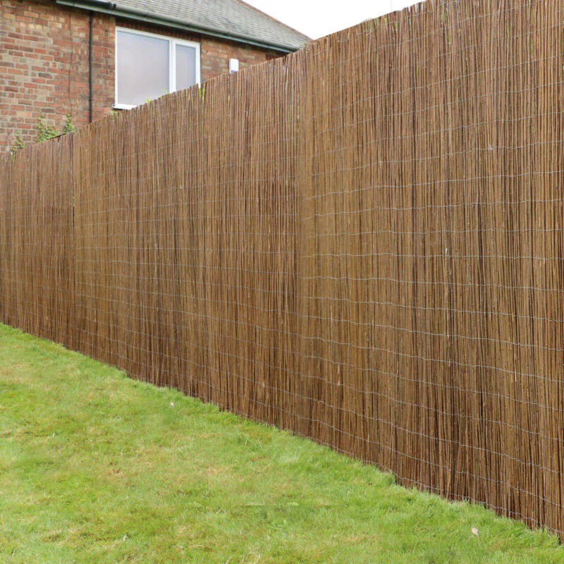 Natural reed garden fencing used as a border in a garden setting.