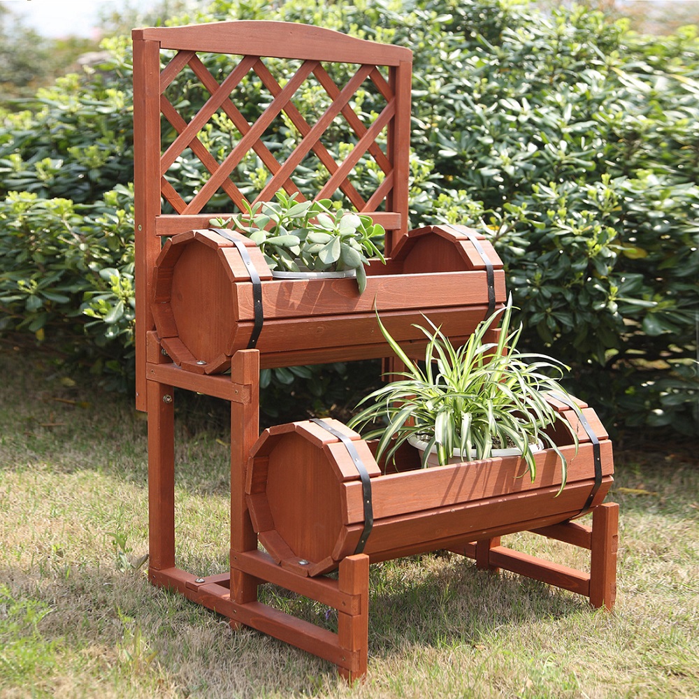 Wooden twin barrel plant trellis with two planters containing green plants, set in a garden.