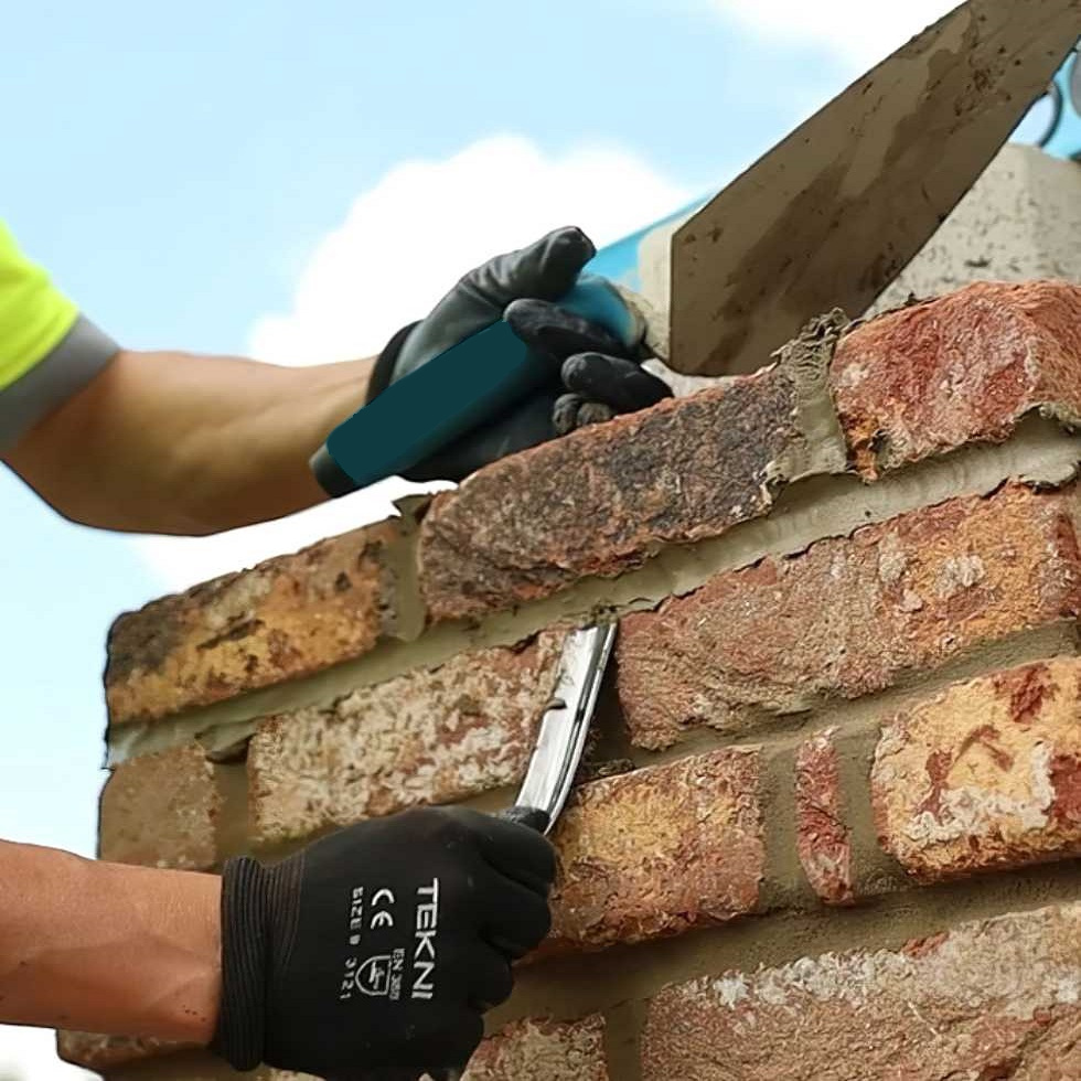 Person using a Marshalltown Brick Mortar Jointer Pointing Iron on a brick wall.