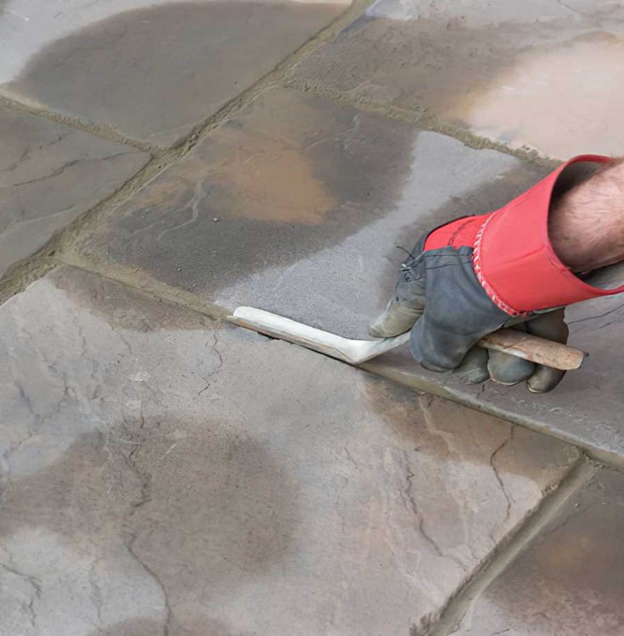 Person using a Marshalltown Brick Mortar Jointer Pointing Iron on paving stones.