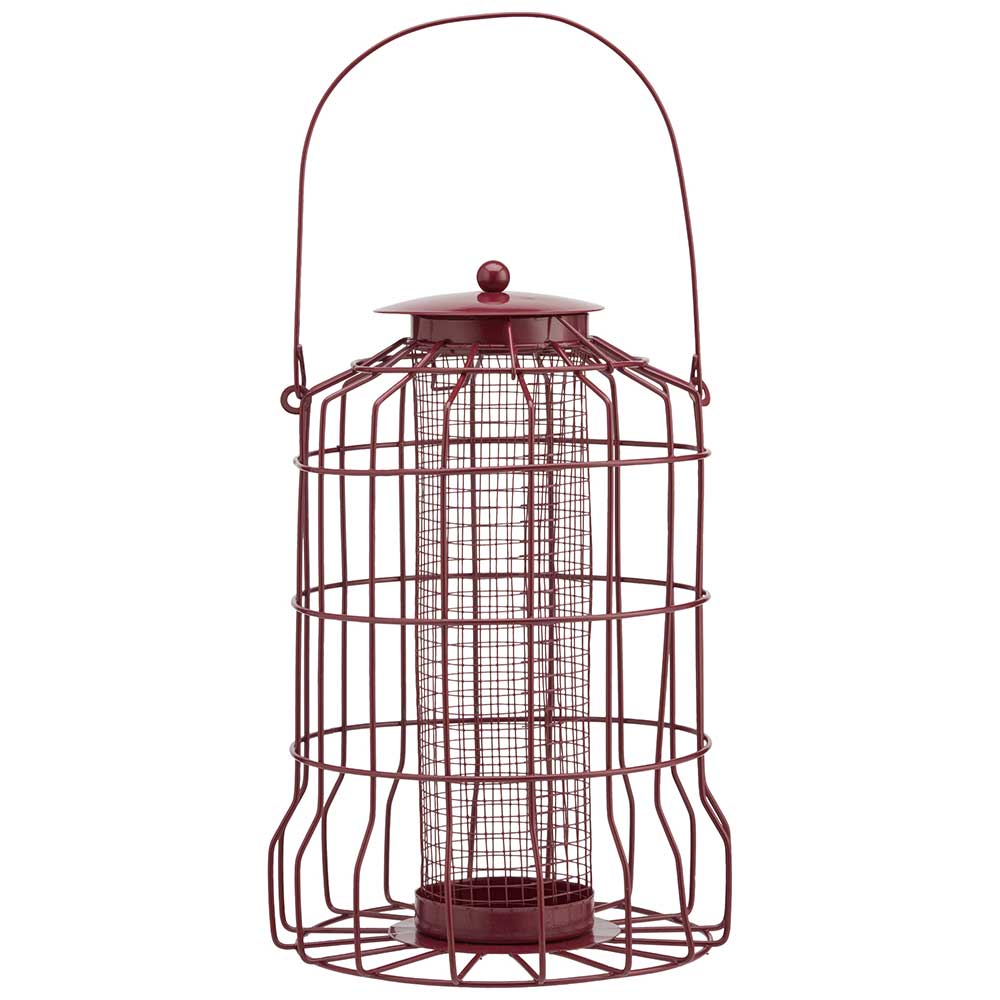 Red metal bird feeder with a protective cage for peanuts, designed to prevent squirrels from accessing the food.
