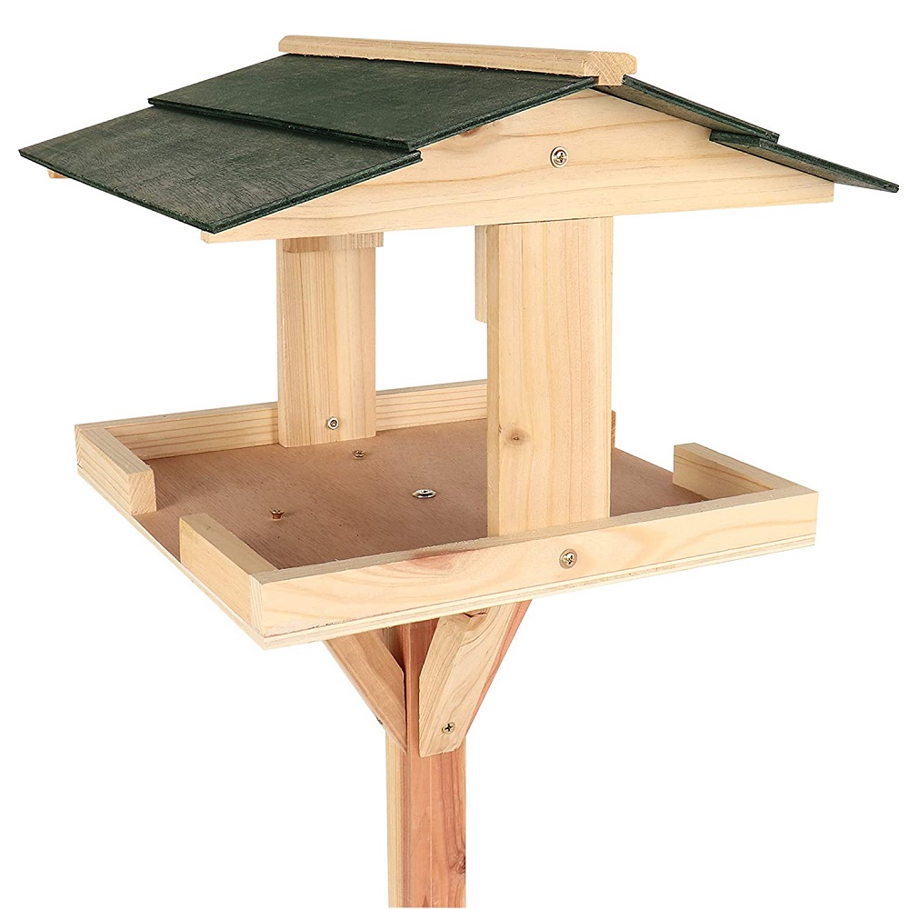 Wooden garden bird table with a green roof for outdoor feeding.