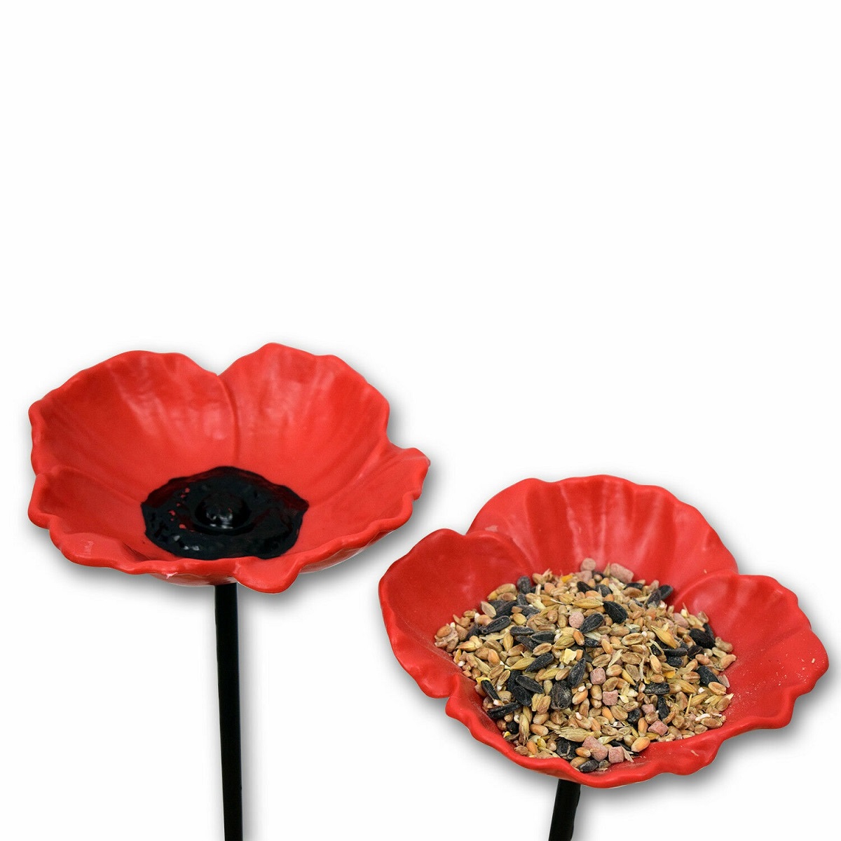 Red poppy-shaped bird feeders with wild bird food for small birds.