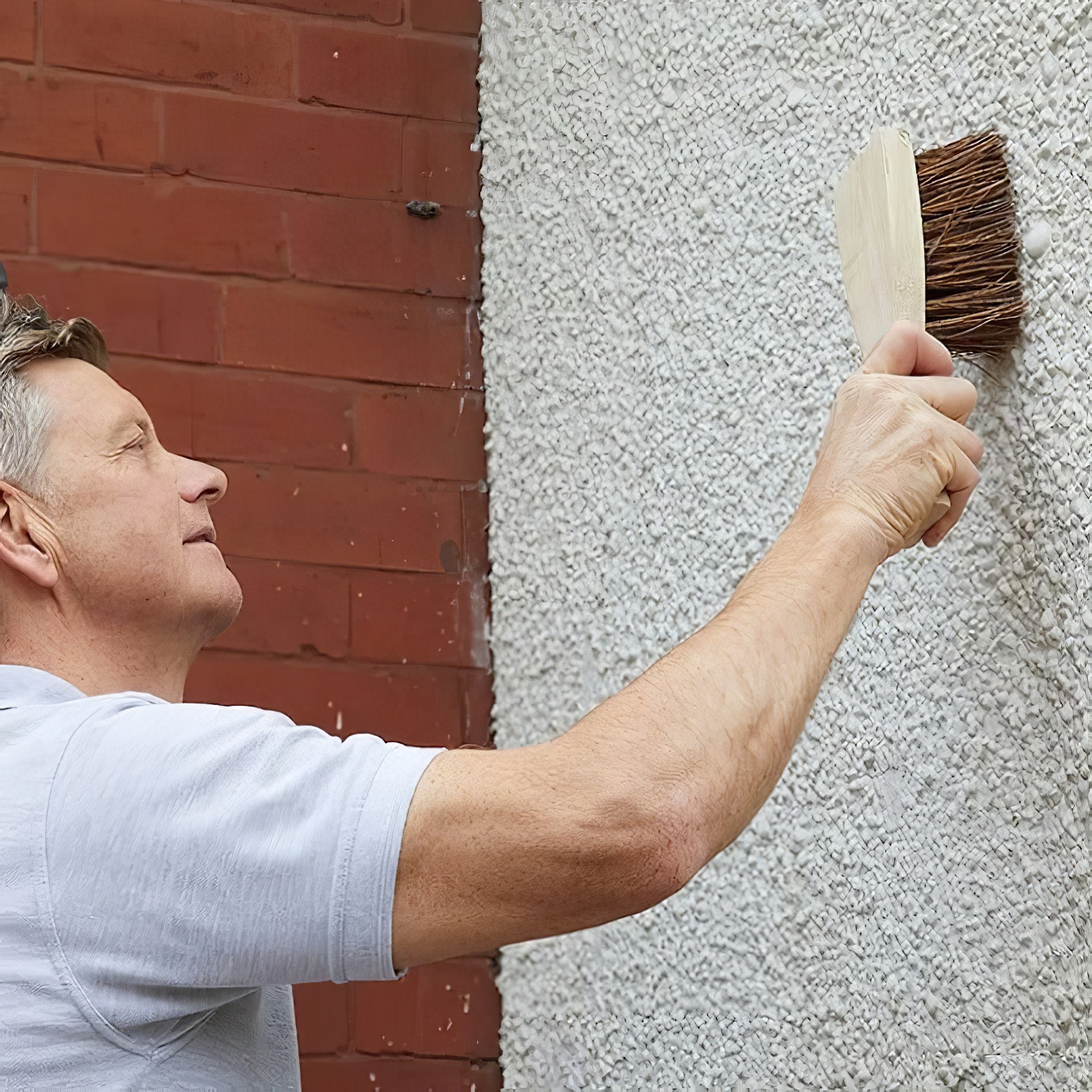 Wooden-handled churn brush with stiff bristles for cleaning masonry and brickwork cleaning wall
