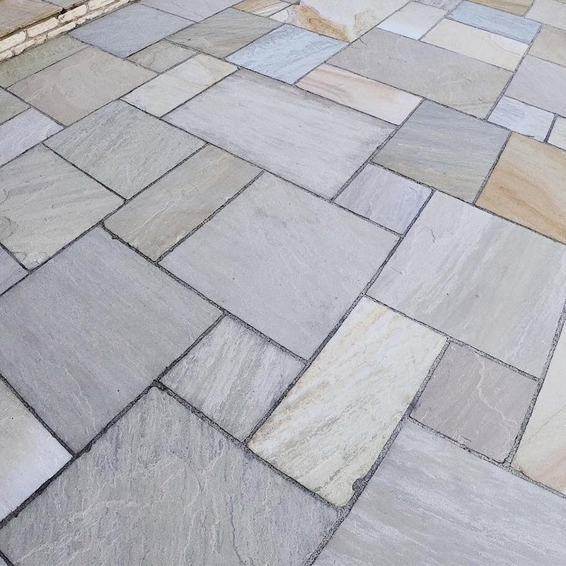Close-up view of a paved area with Indian sandstone tiles.