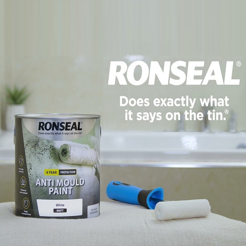 Ronseal Anti-Mould Paint White Matt 750ml tin with paint roller in a bathroom setting.