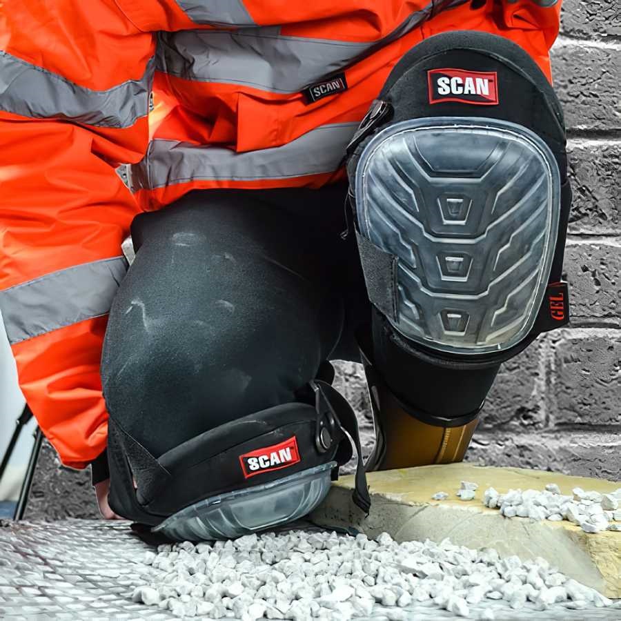 Person wearing Scan Professional Gel Knee Pad Protector on gravel surface.