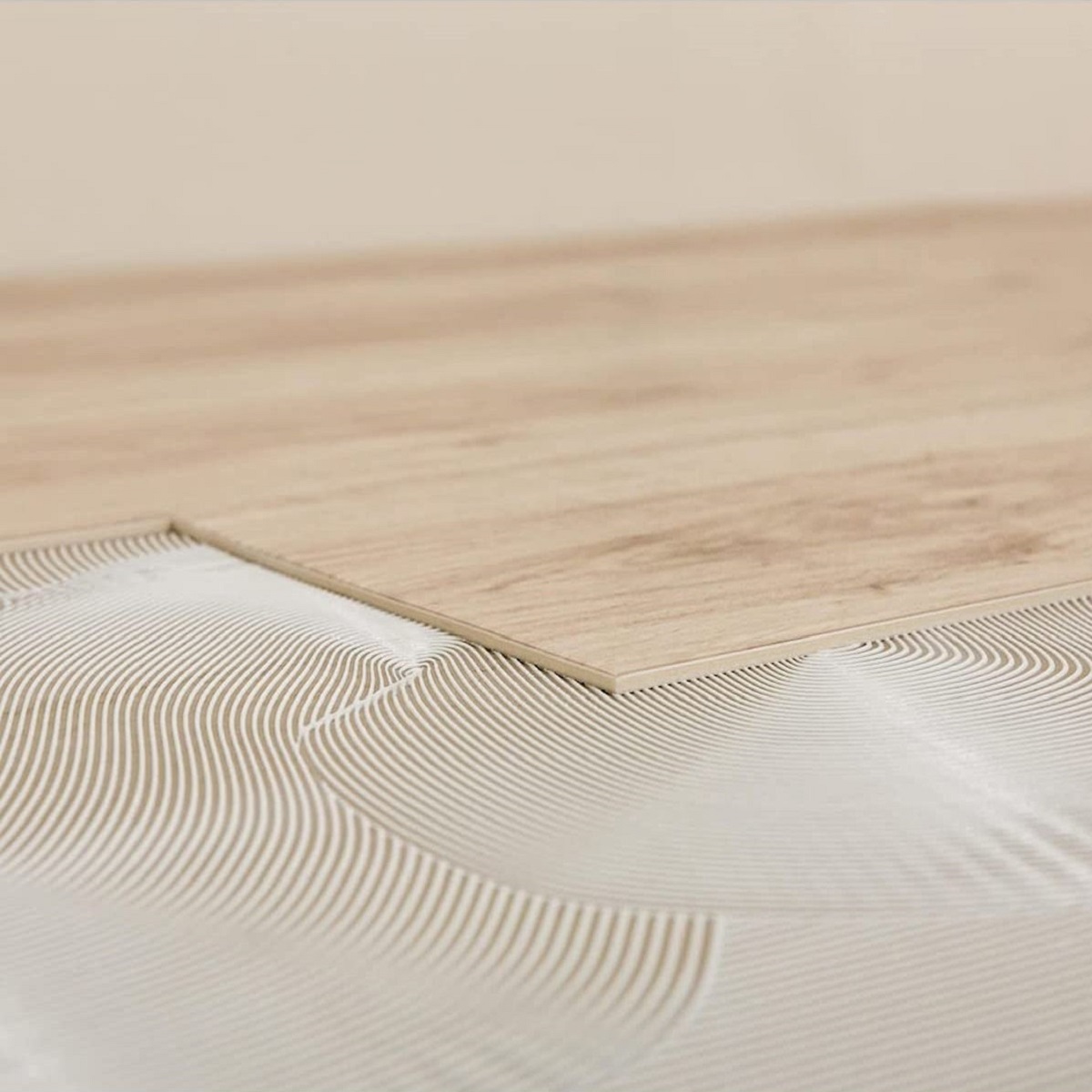 Close-up of a wooden surface being primed with a resin damp proofing primer.