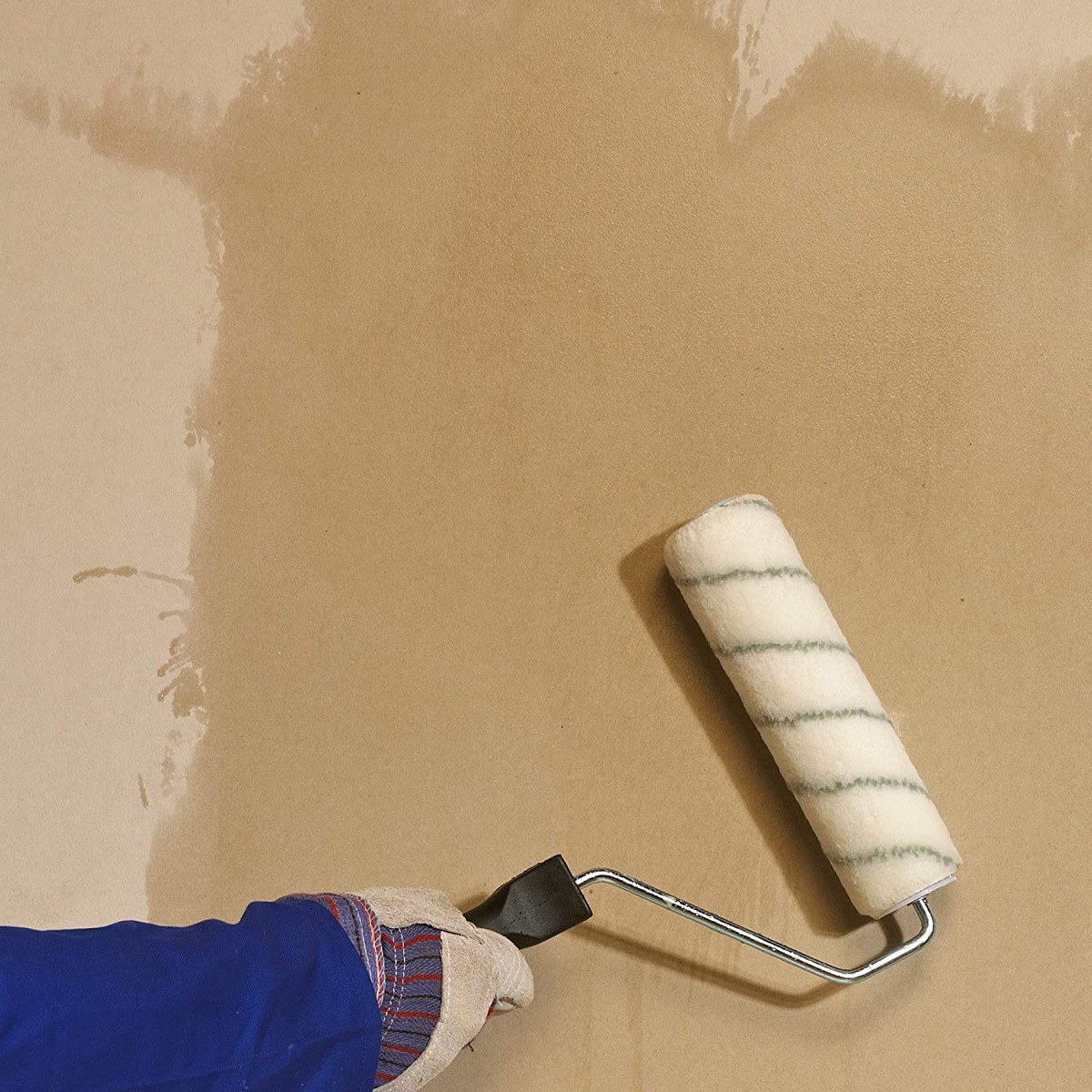 Person applying liquid with a roller on a surface, showing the use of Sika Sikabond Waterproof PVA.