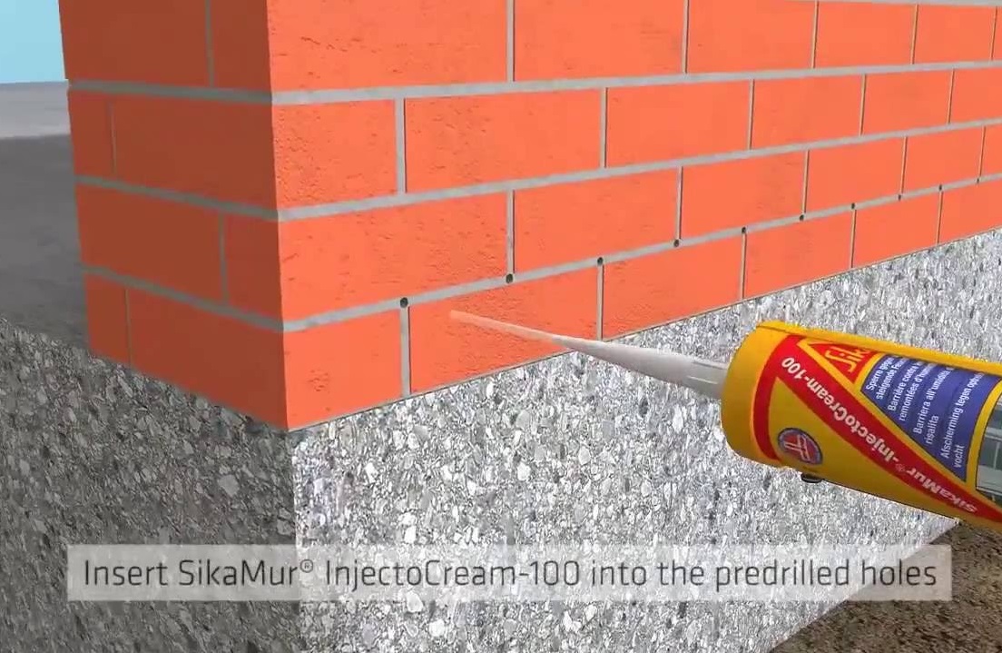 Illustration showing the application of SikaMur InjectoCream 100 into pre-drilled holes in a brick wall.