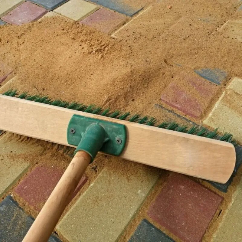 Sweeping sand on patio bricks Top 5 Products for Maintaining Your Patio and Driveway