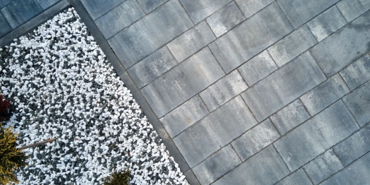 Garden design featuring pebbles and paving Aerial view of a garden with white pebbles and grey paving stones