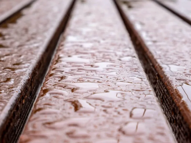 Rain-soaked wooden planks Close-up of wet wooden decking with rain droplets