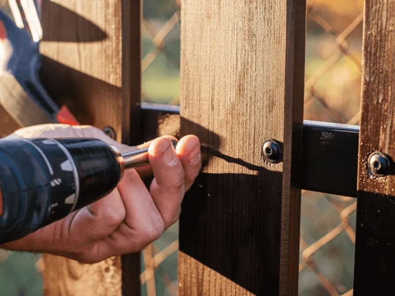 Securing a wooden fence with a power drill Fencing Fixings and Accessories