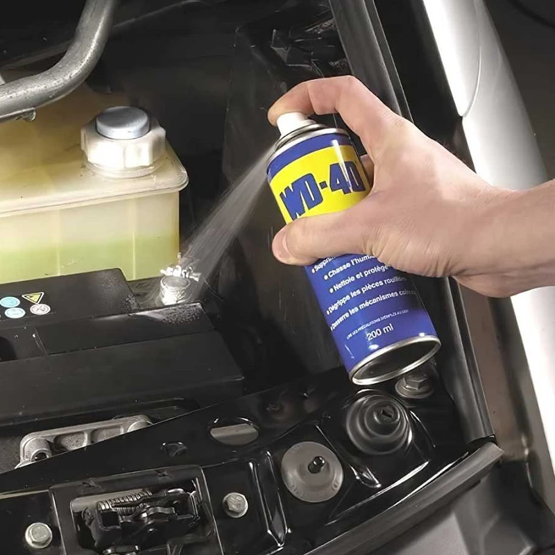 WD-40 sprayed onto a car battery terminal to prevent corrosion