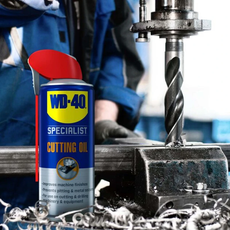 WD40 Specialist Multi-Purpose Cutting Oil Spray can next to a metal drilling machine in use.